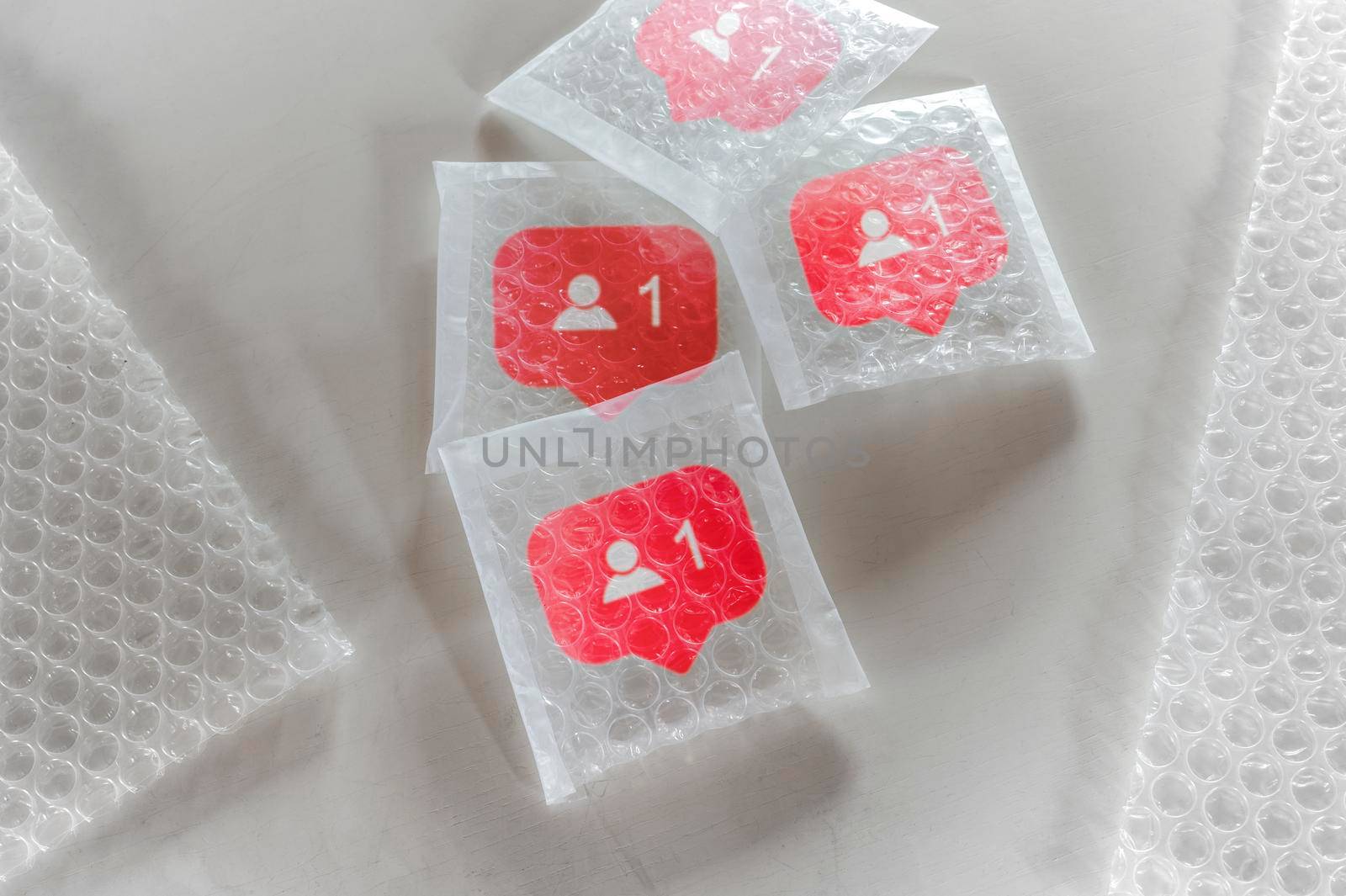 Packaging social symbols and icons with bubble wrap.