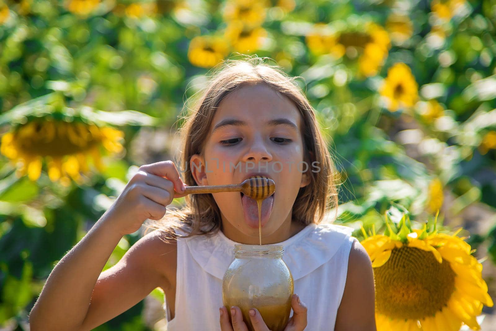 The child eats flower honey. Selective focus. Nature.