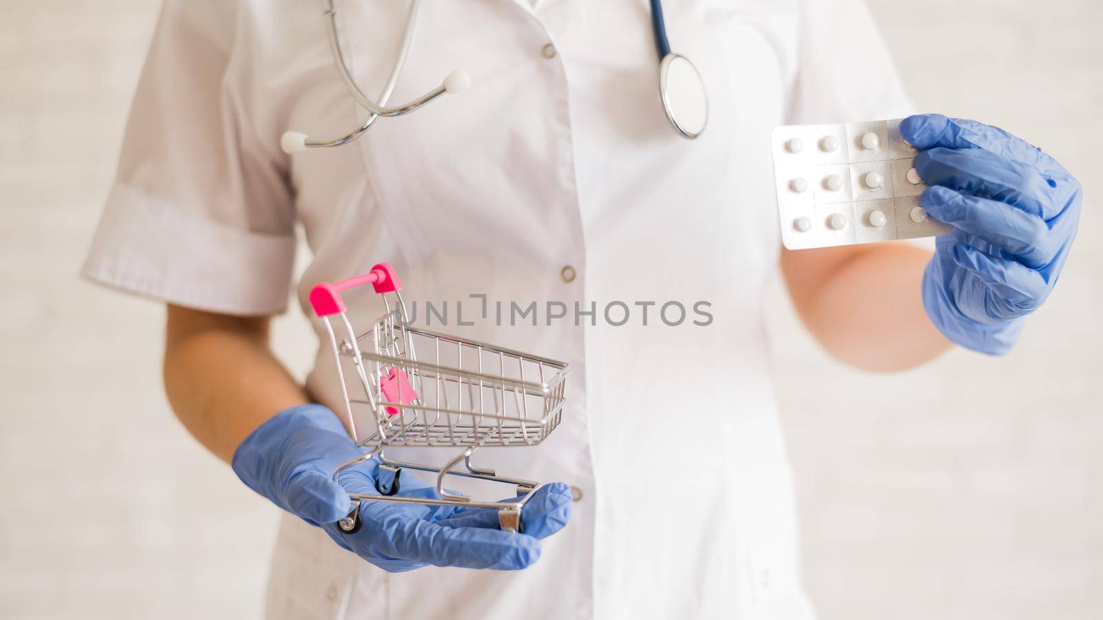 A faceless doctor puts a blister of pills in a mini shopping cart