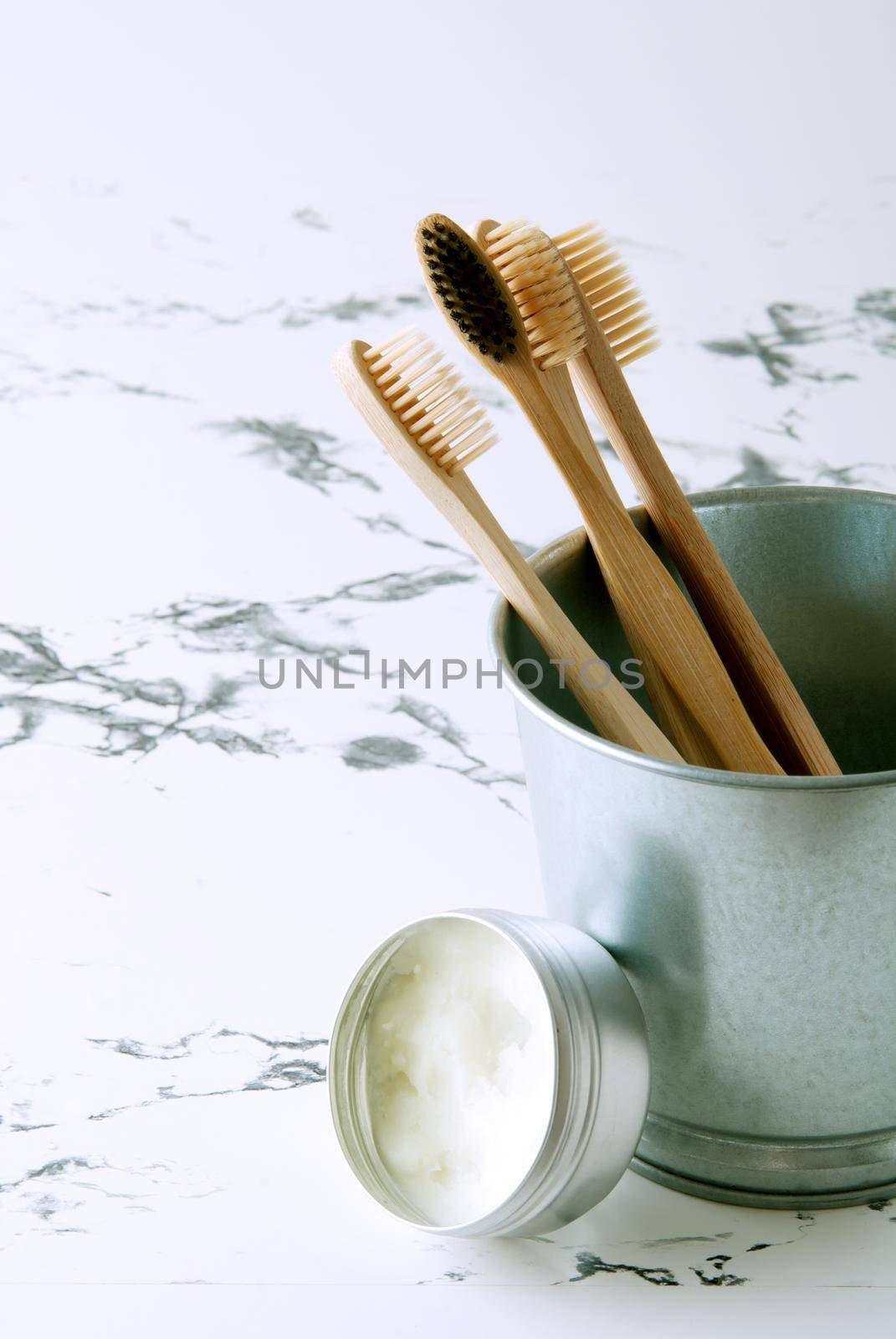 bamboo teeth brushes in bathroom on marbel background by maramorosz