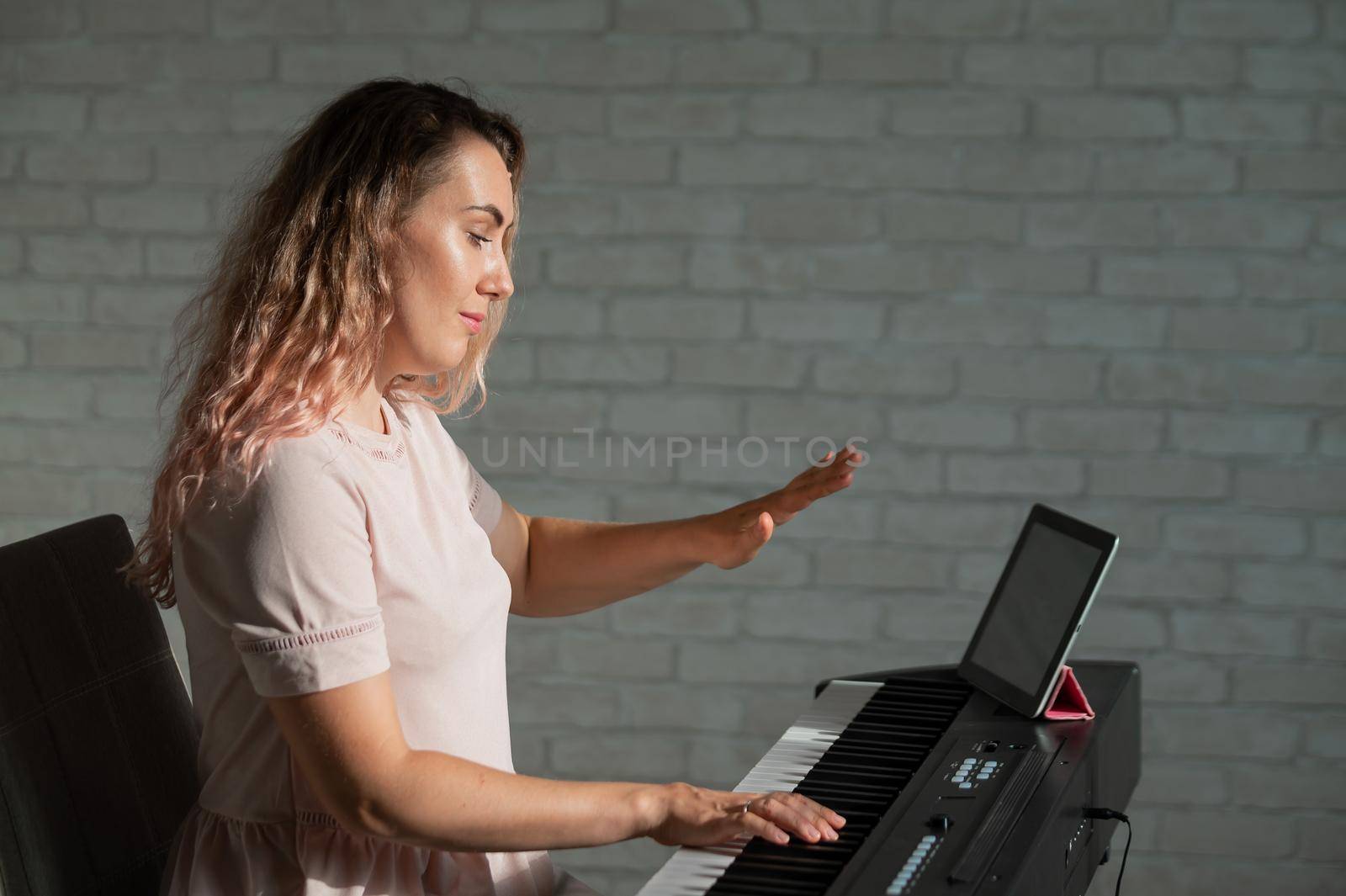 Female singing teacher at online lesson on digital tablet by mrwed54