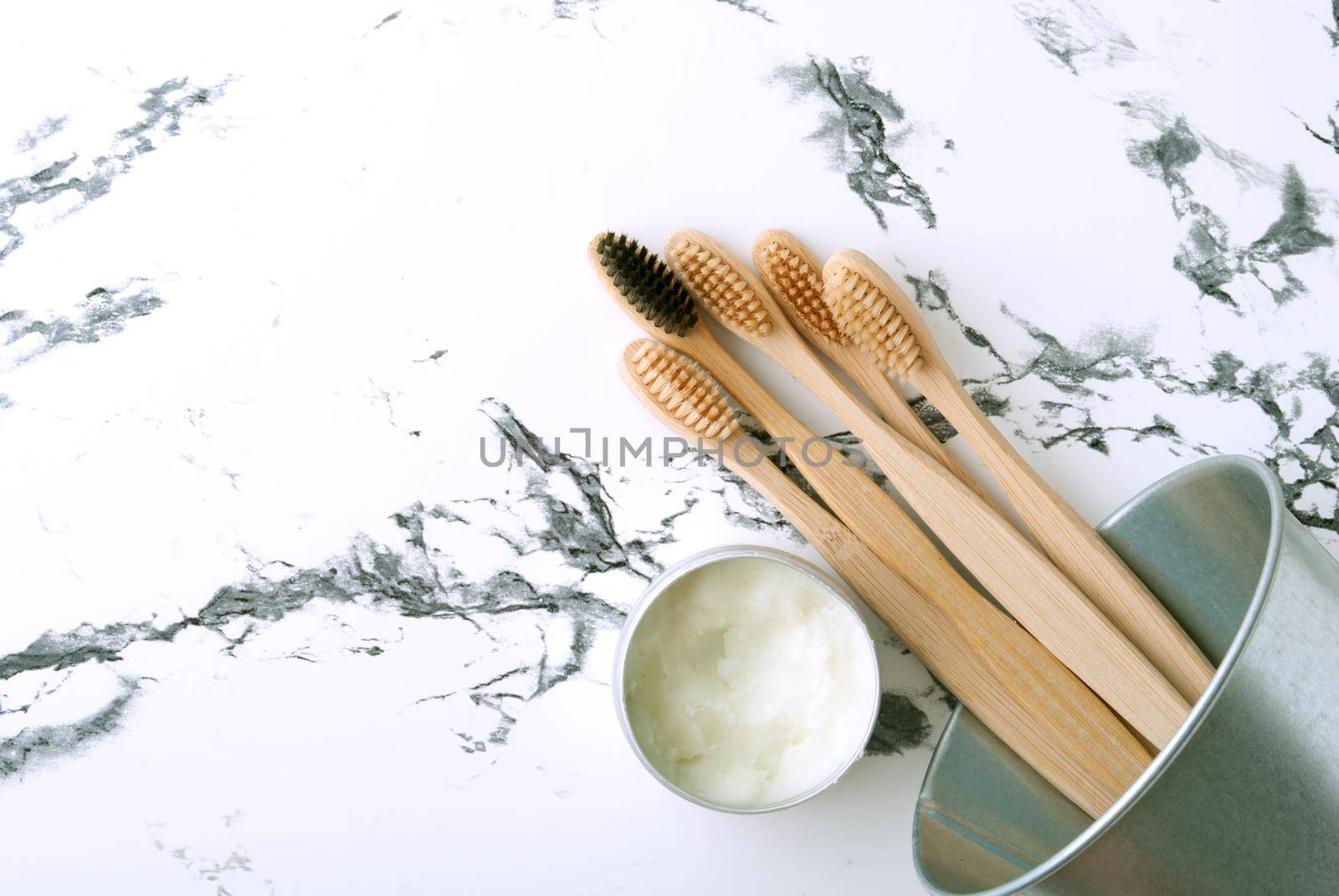 bamboo teeth brushes in bathroom on marbel background with copy space by maramorosz