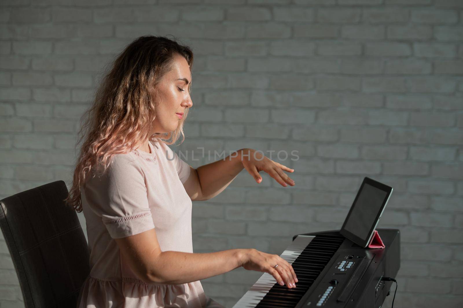 Female singing teacher at online lesson on digital tablet by mrwed54