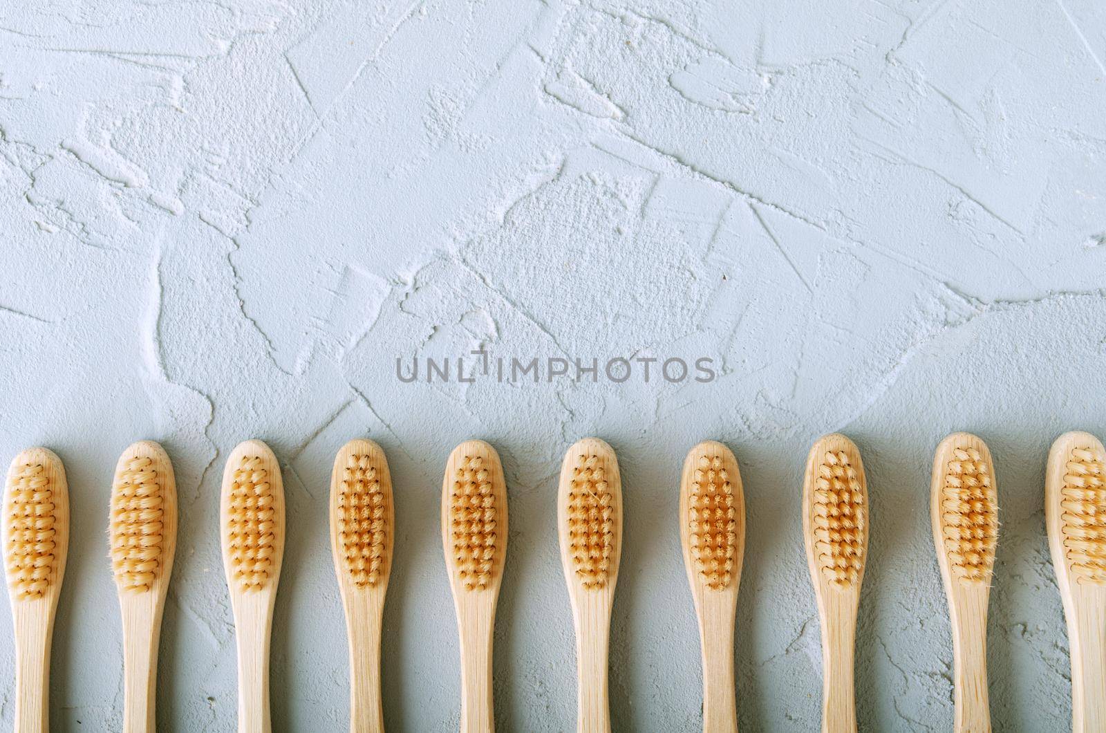 bamboo toothbrushes on a concrete background with copy space by maramorosz