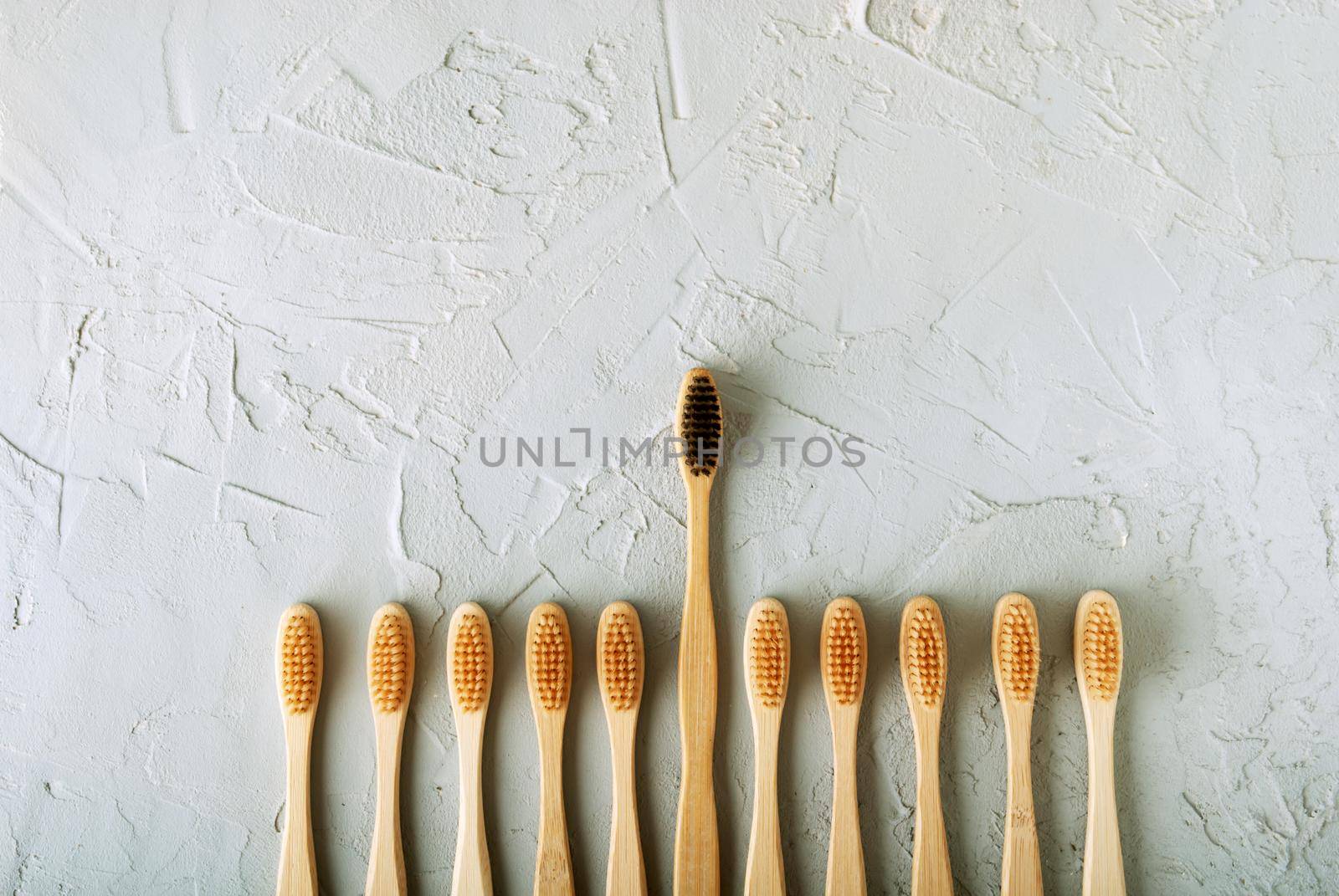 bamboo toothbrushes on a concrete background with copy space by maramorosz