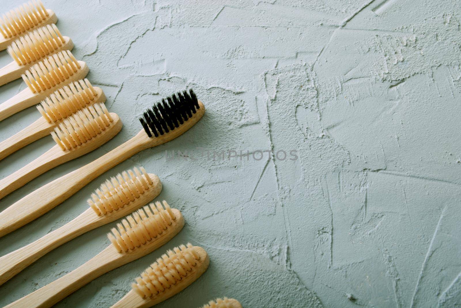 bamboo toothbrushes on a concrete background with copy space by maramorosz