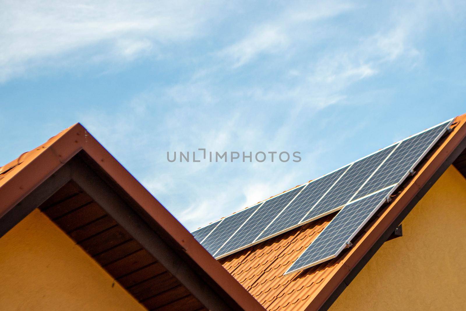 House roof with photovoltaic modules. Historic farm house with modern solar panels on roof and wall High quality photo