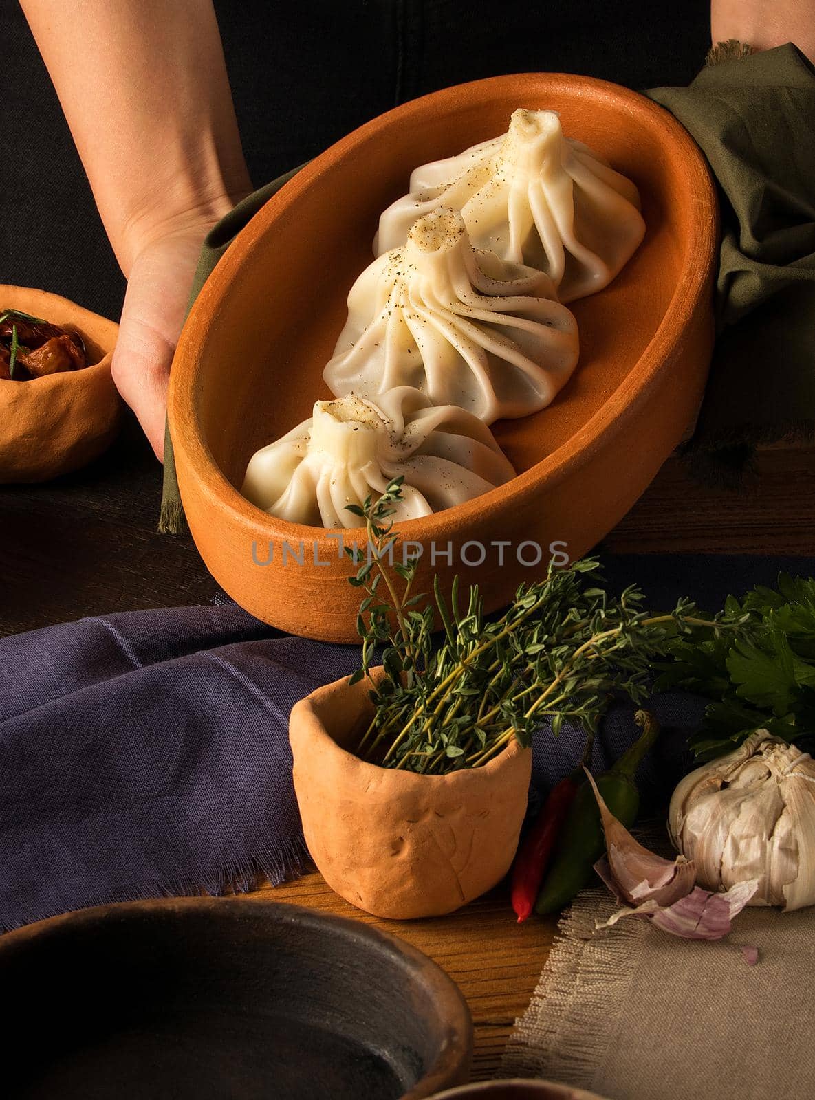 A vertical shot of a luxurious restaurant table with a gourmet khinkali dish