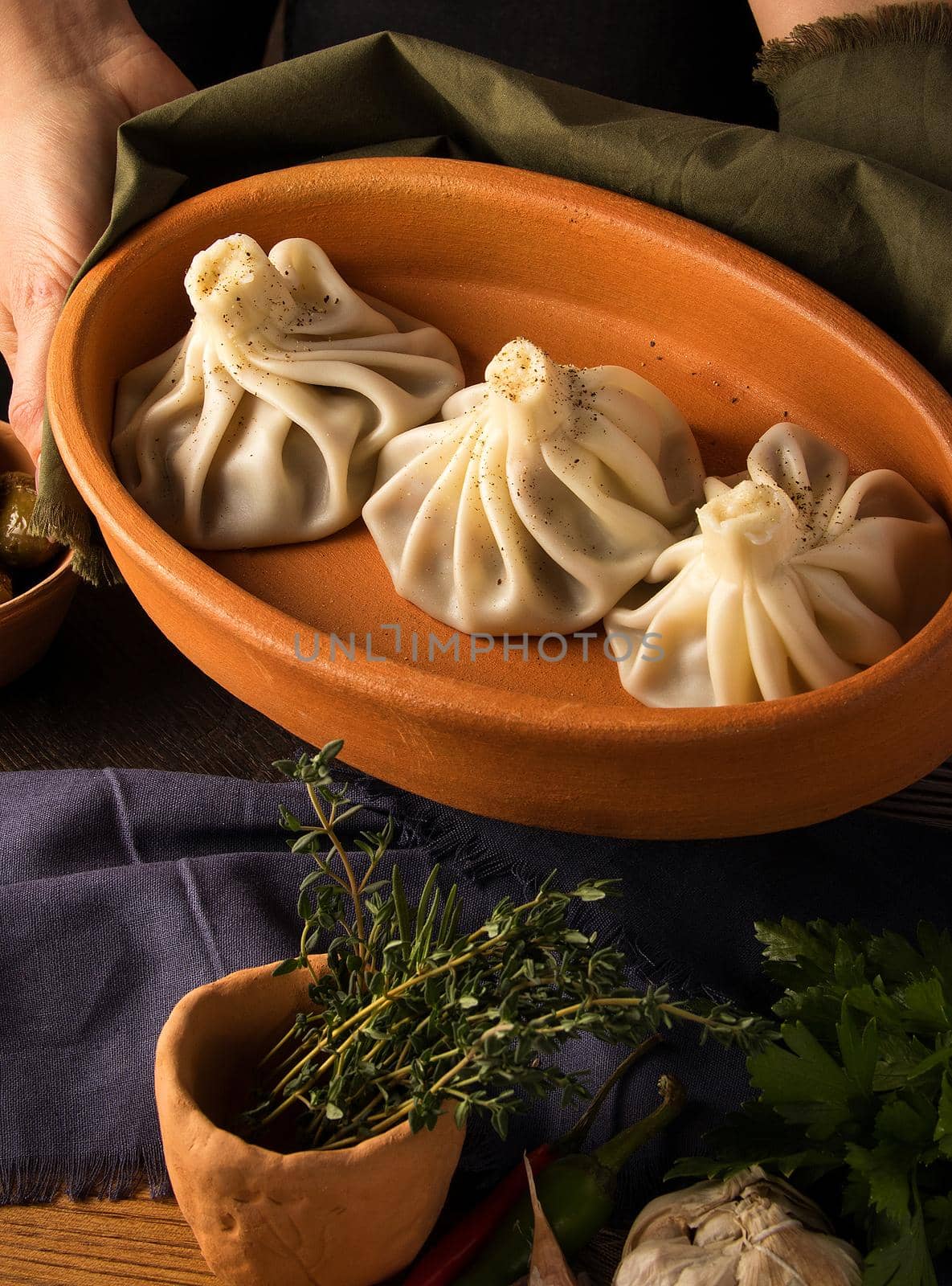 Vertical shot of a luxurious restaurant table with a gourmet khinkali dish by A_Karim