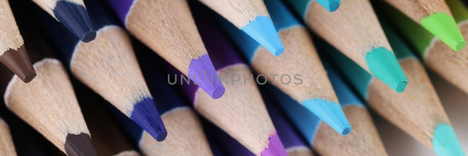 Close-up of sharpened pencils for drawing laying on each other forming stack. Pigmented crayons for painting on paper. Idea, vision, imagination concept