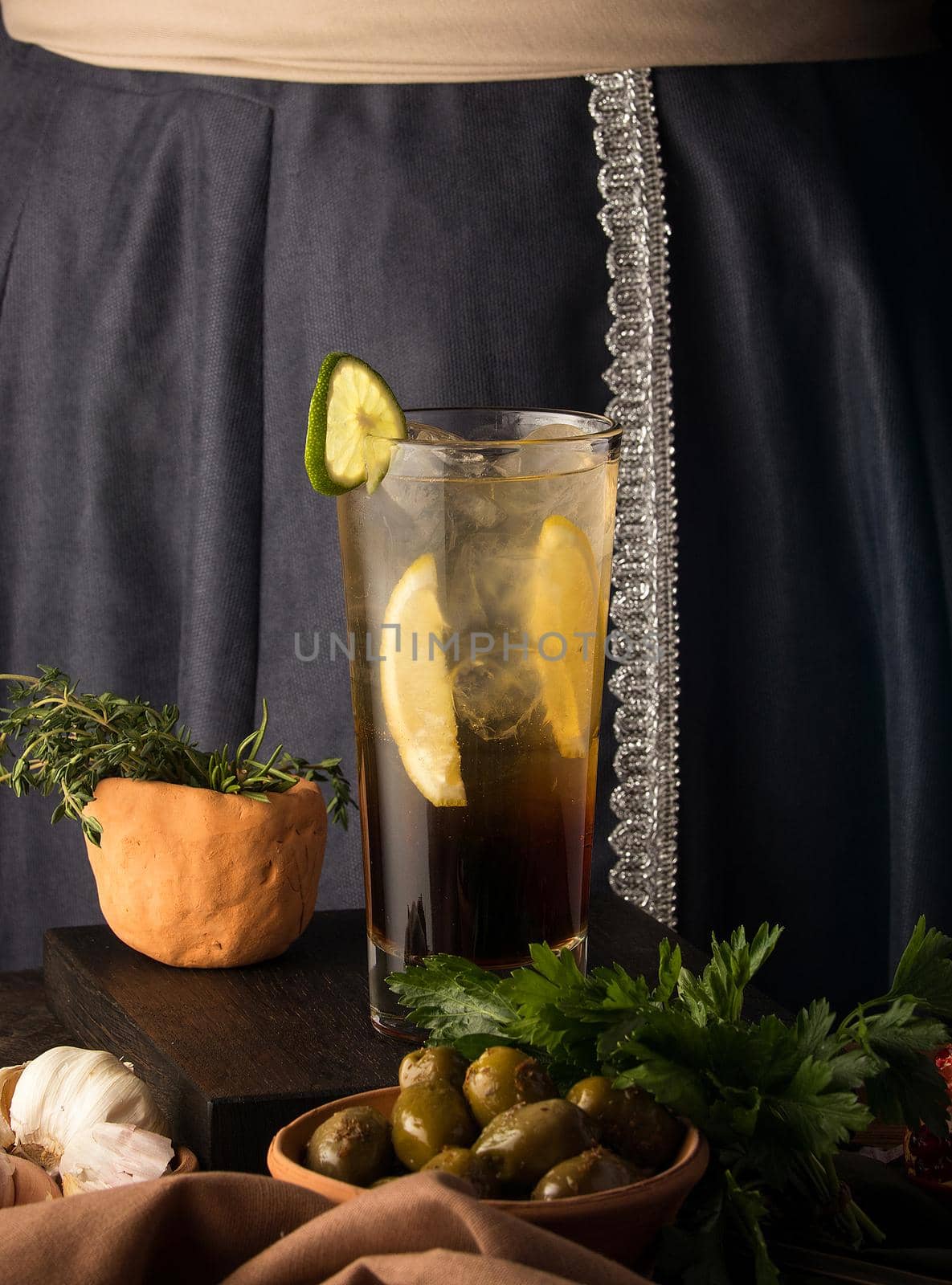 A vertical shot of a refreshing cold drink and some appetizers