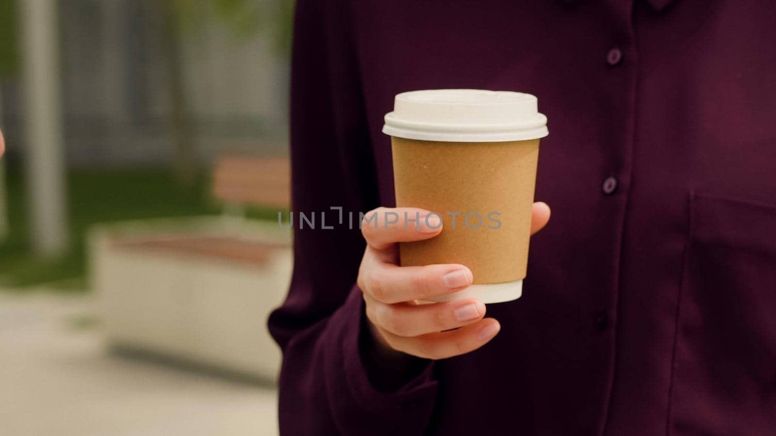 Close up hand of a business woman holding coffee and talking with somebady. by RecCameraStock