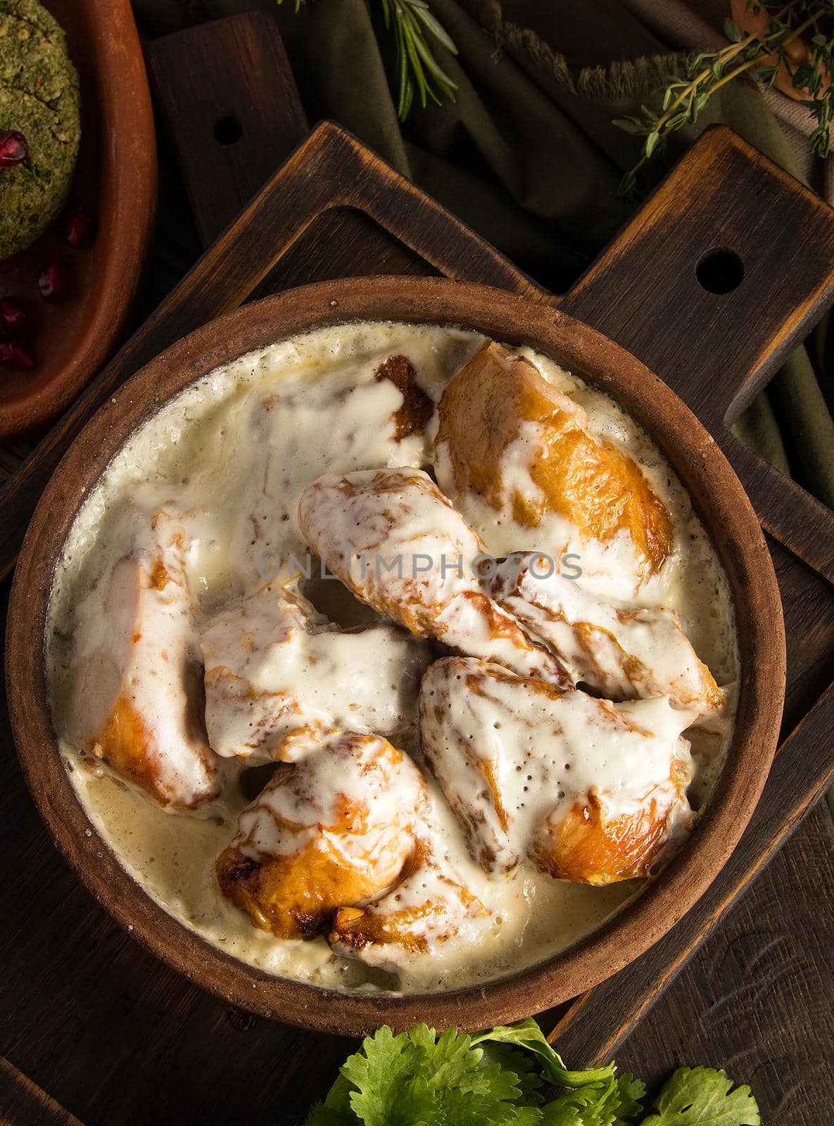 Top view of a chicken covered in a creamy sauce by A_Karim