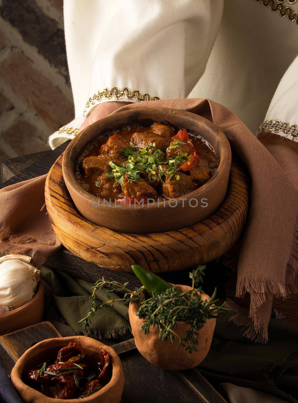 Vertical shot of a waitress presenting a meat stew by A_Karim