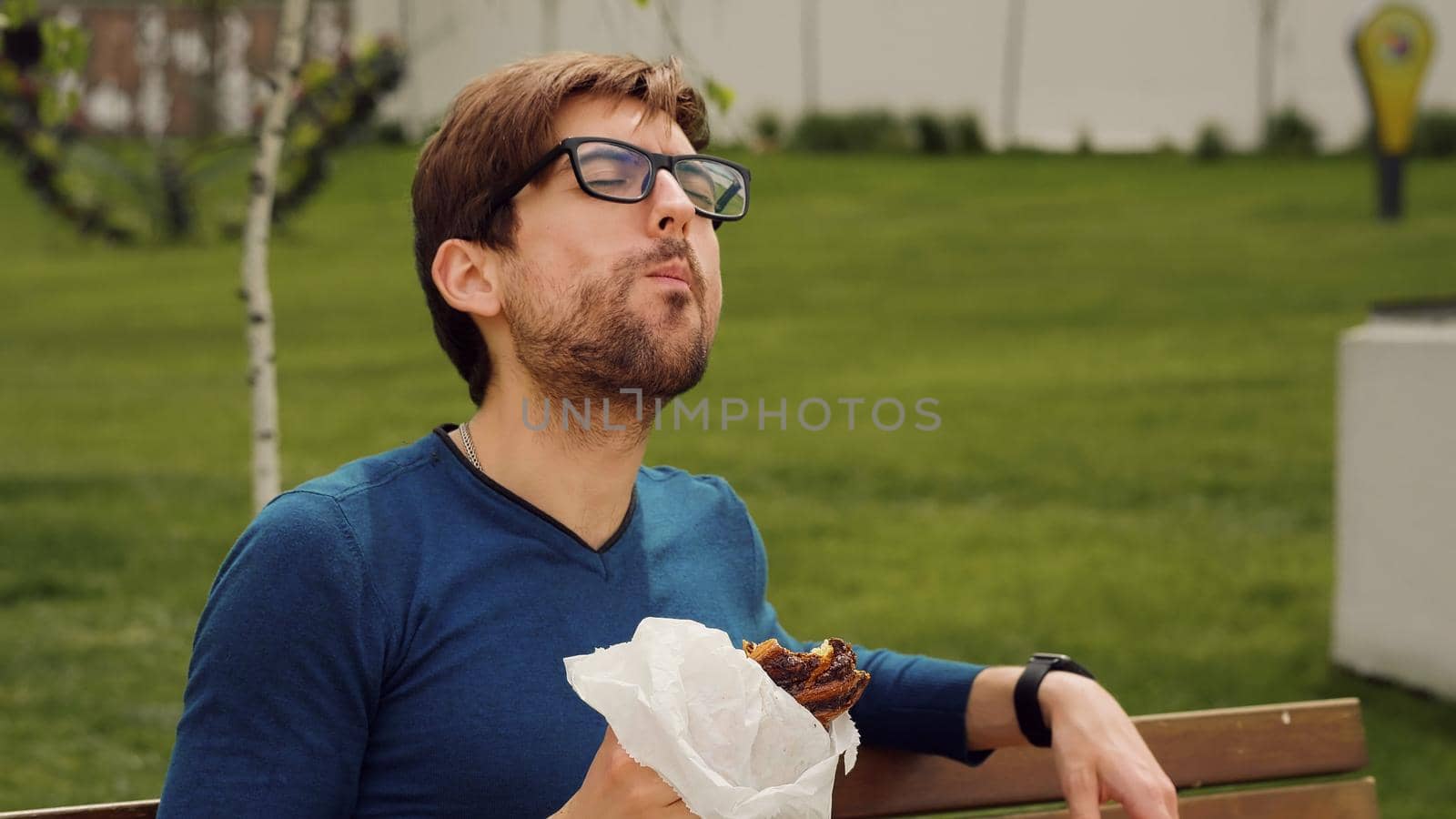 Employee Taking Break Work. Young man Lunch Eating snack. Handsome man enjoying food. Portrait of hungry man.