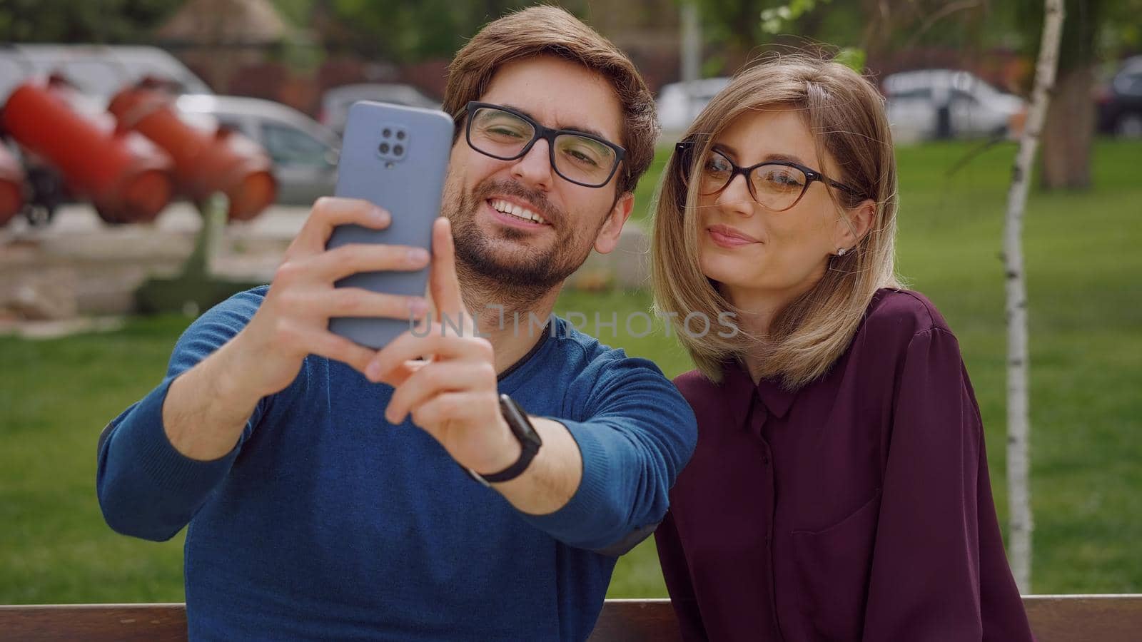 Friends woman and man take selfie with phone by RecCameraStock