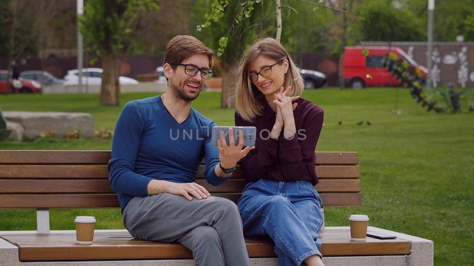 Young smiling couple conducting a video call by RecCameraStock