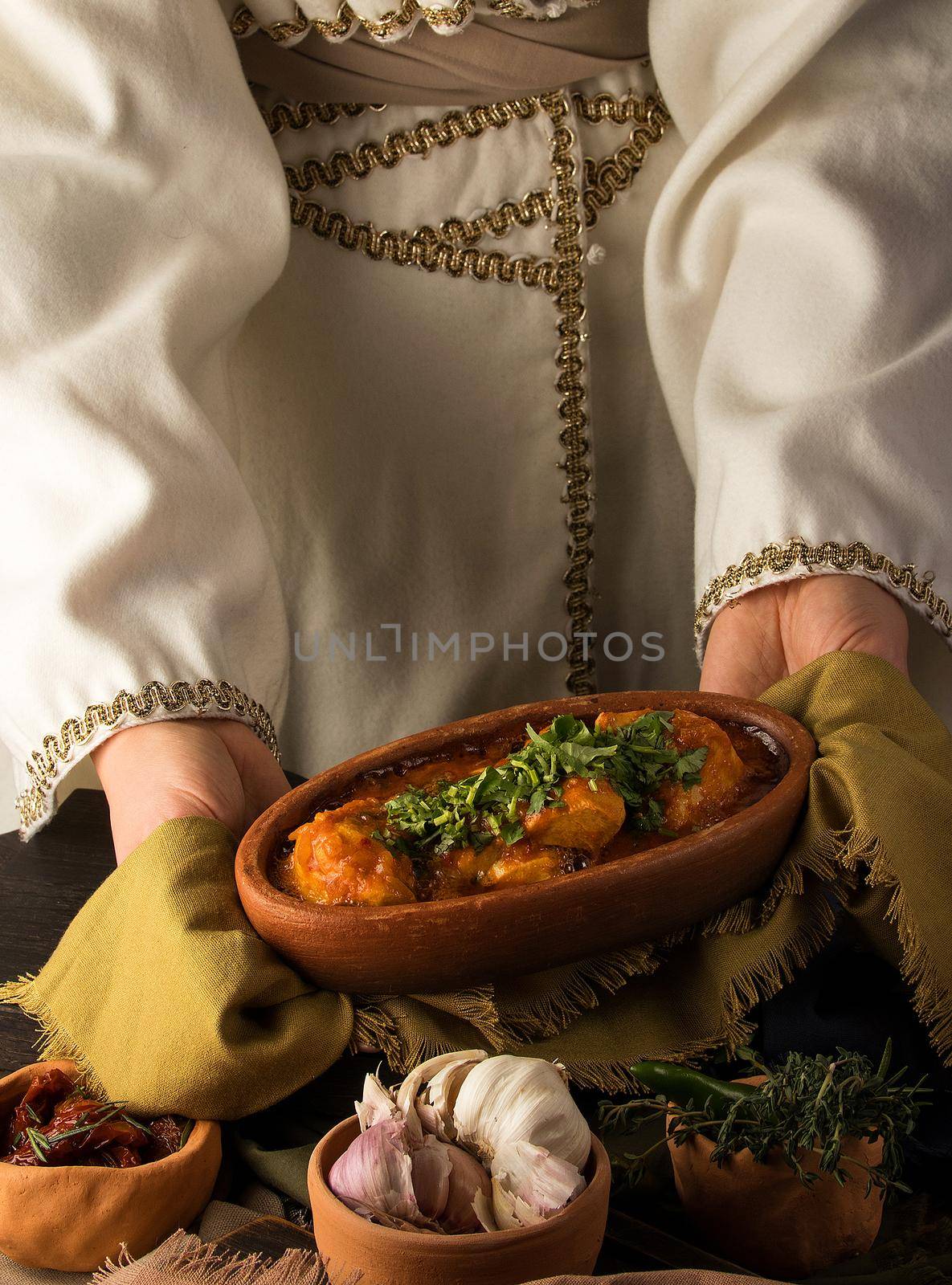 A waitress presenting a chicken stew