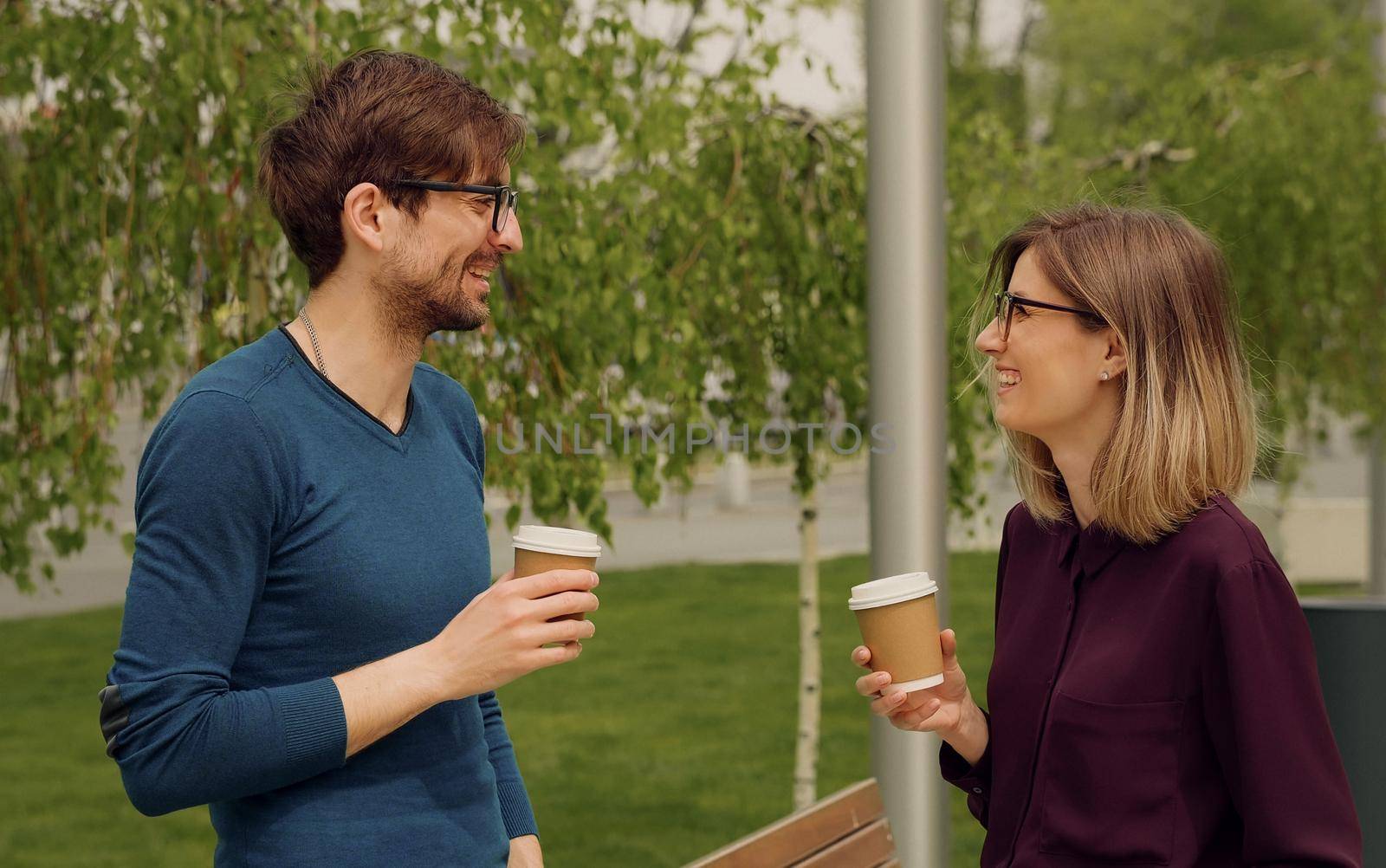 Smiling caucasian businesswoman and man Funny Coversation talking. Coworkers friendly discussion during lunch time. Confident Employees.