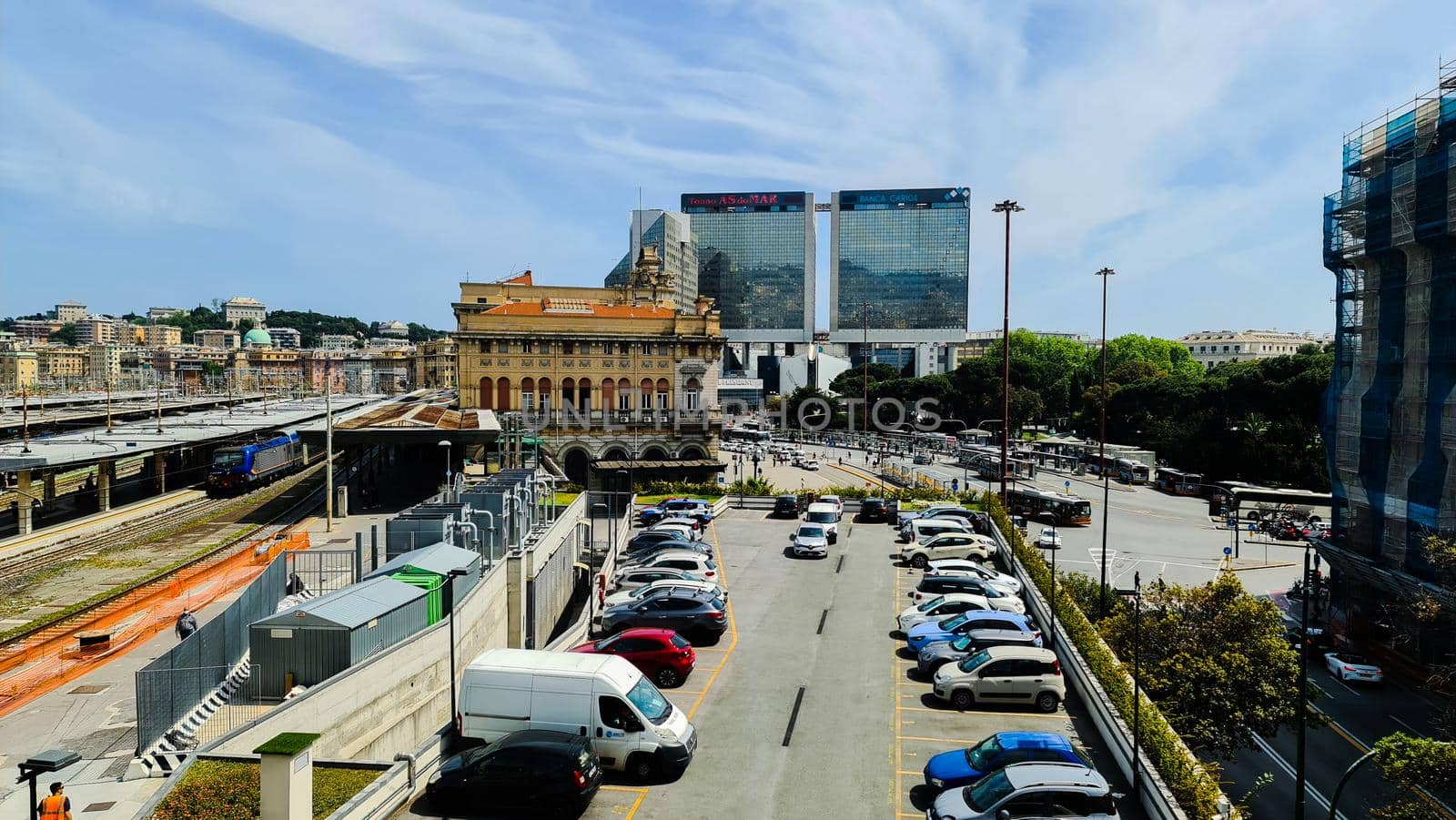 Genova, Italy-January 29, 2022: Beautiful modern high-rise buildings against the sky. 3d illustration on the theme of business success and technology. clouds reflection on the mirror.Industrial zone.