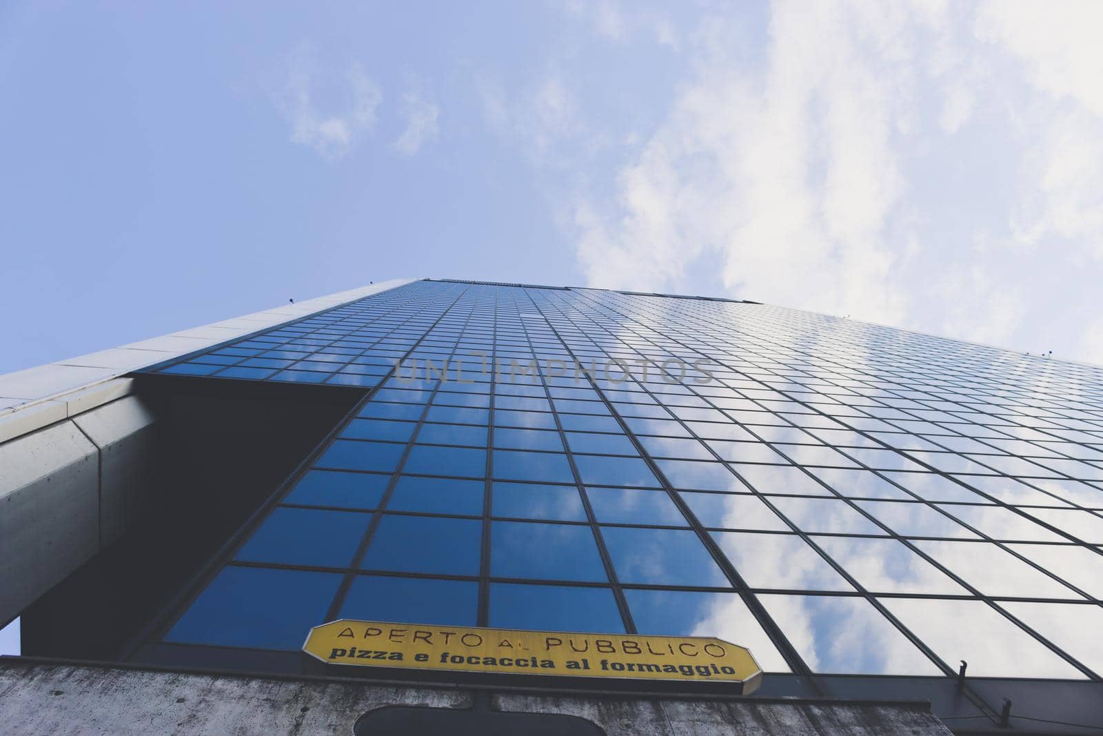 Genova, Italy-January 29, 2022: Beautiful modern high-rise buildings against the sky. 3d illustration on the theme of business success and technology. clouds reflection on the mirror.Industrial zone.