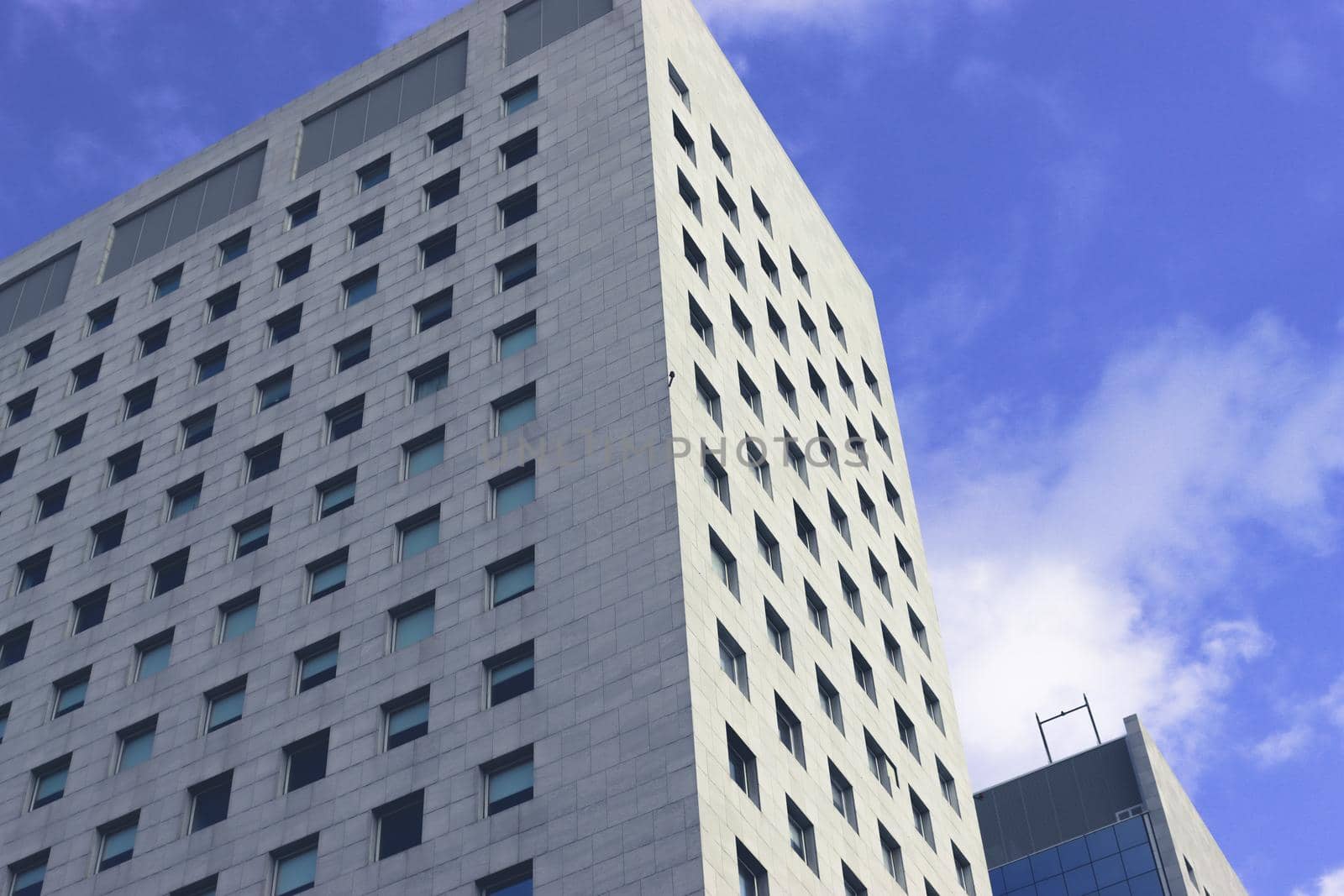 Genova, Italy-January 29, 2022: Beautiful modern high-rise buildings against the sky. 3d illustration on the theme of business success and technology. clouds reflection on the mirror.Industrial zone.