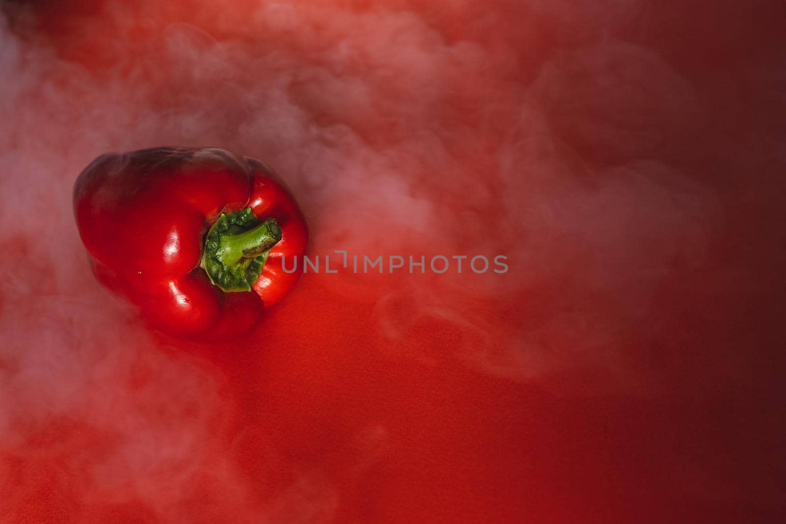 SWEET, fresh RED PEPPER ON RED BACKGROUND With smoke around, pepper. photo for the menu, proper nutrition. fresh vegetables by Anyatachka