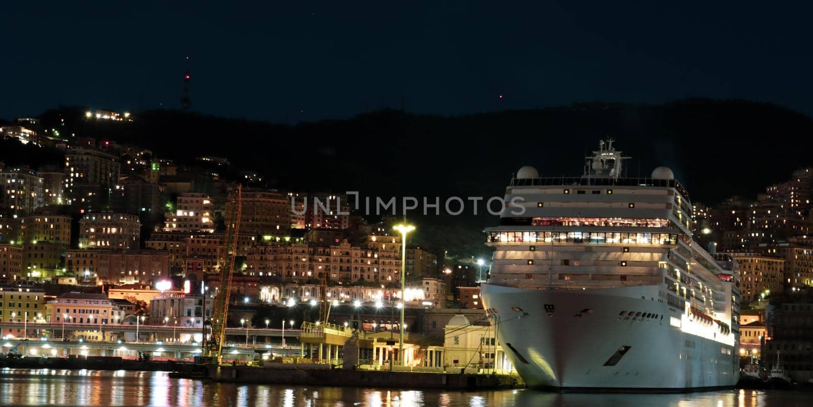 Genova, Italy- June 20,2022: Port of Porto Antico harbor with luxury  yachts and attractions, Bigo construction in historical centre of old european city Genoa with beautiful sunset reflection.