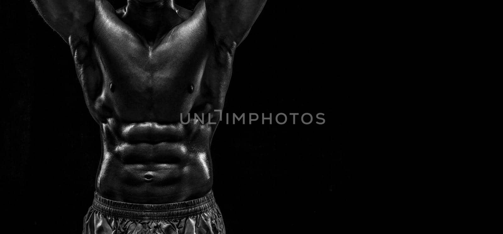 Part of a man's body on a dark background with copyspace. Studio shot on black background.