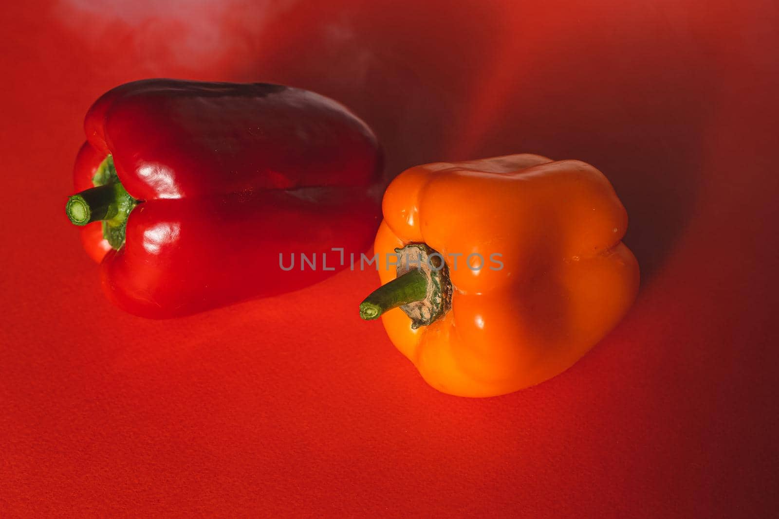 SWEET RED AND ORANGE PEPPERS ON A RED BACKGROUND by Anyatachka