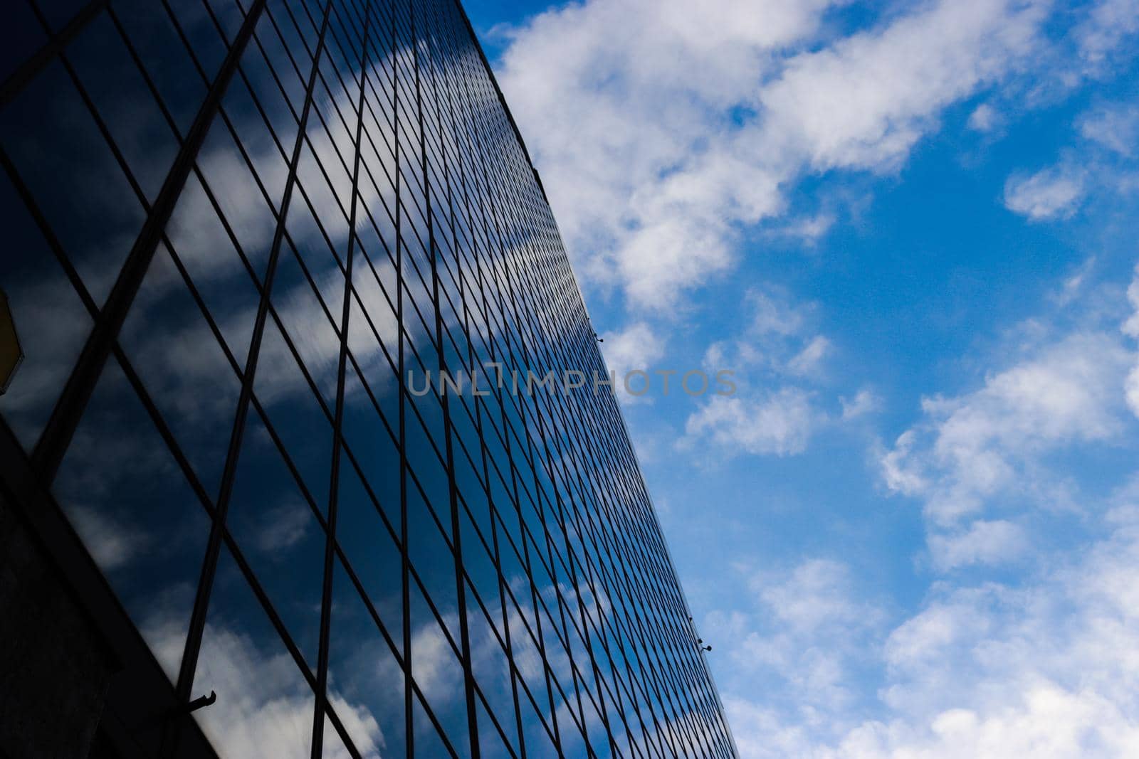 Genova, Italy-January 29, 2022: Beautiful modern high-rise buildings against the sky. 3d illustration on the theme of business success and technology. clouds reflection on the mirror.Industrial zone.