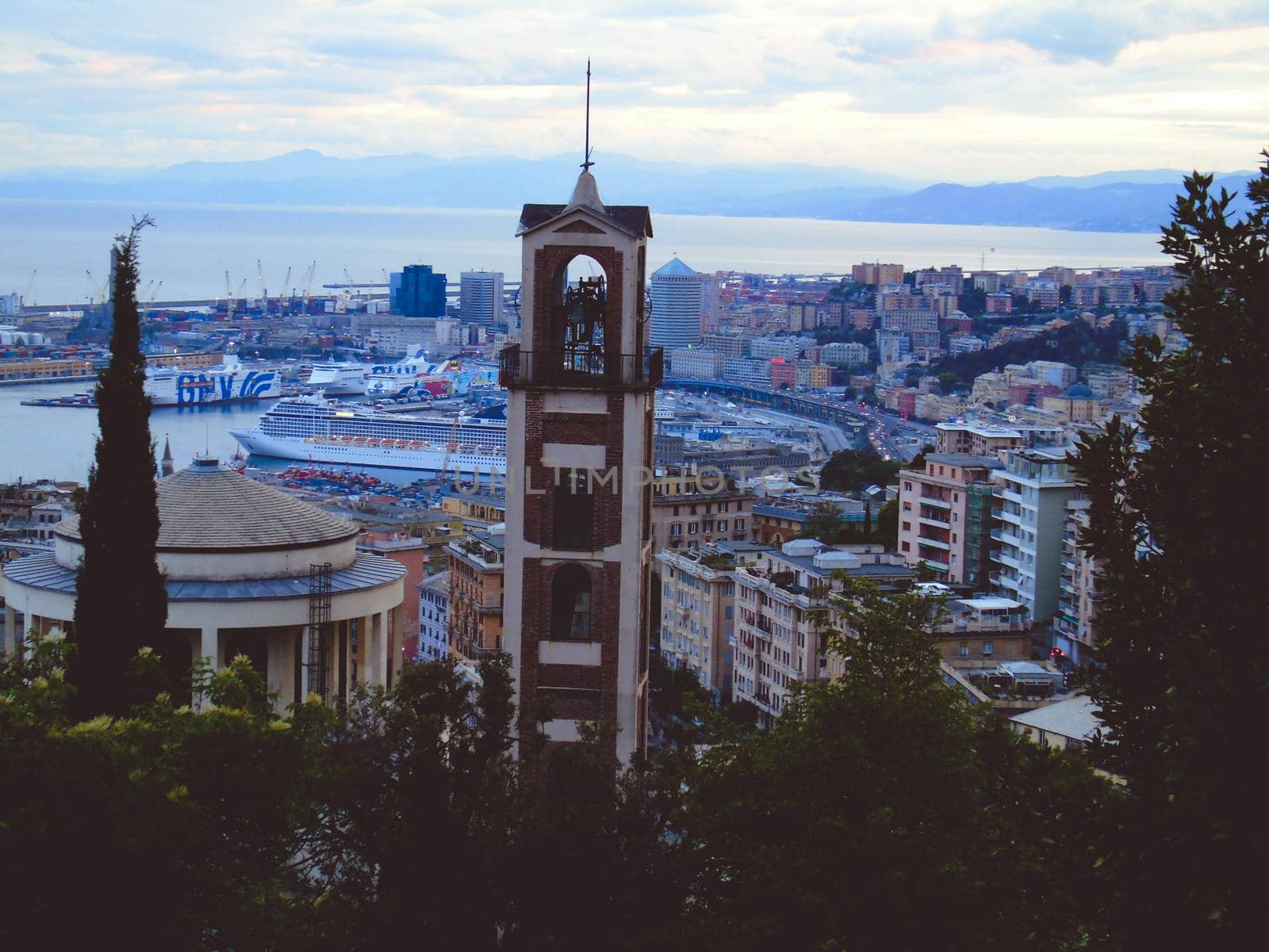 Genova, Italy- June 20,2022: Port of Porto Antico harbor with luxury yachts and attractions, Bigo construction in historical centre of old european city Genoa with beautiful sunset reflection.