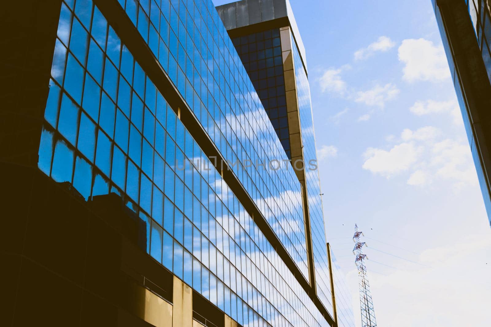 Genova, Italy-January 29, 2022: Beautiful modern high-rise buildings against the sky. 3d illustration on the theme of business success and technology. clouds reflection on the mirror.Industrial zone.