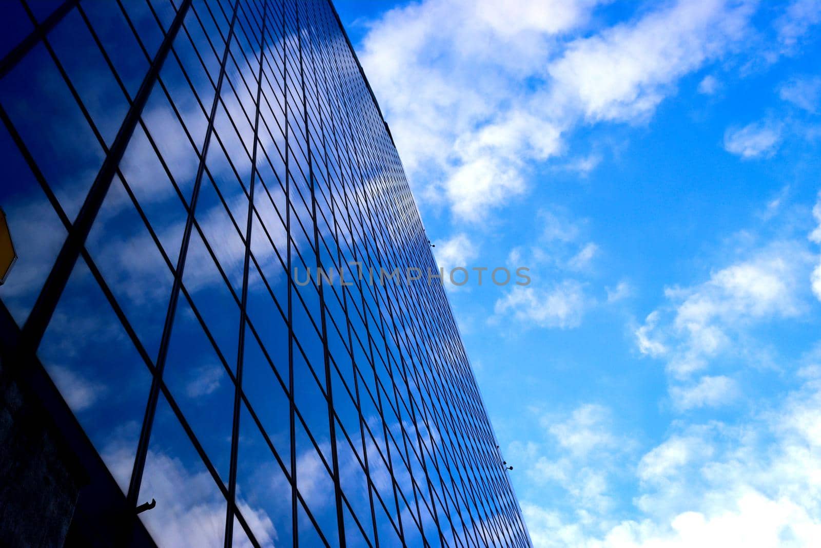 Genova, Italy-January 29, 2022: Beautiful modern high-rise buildings against the sky. 3d illustration on the theme of business success and technology. clouds reflection on the mirror.Industrial zone.