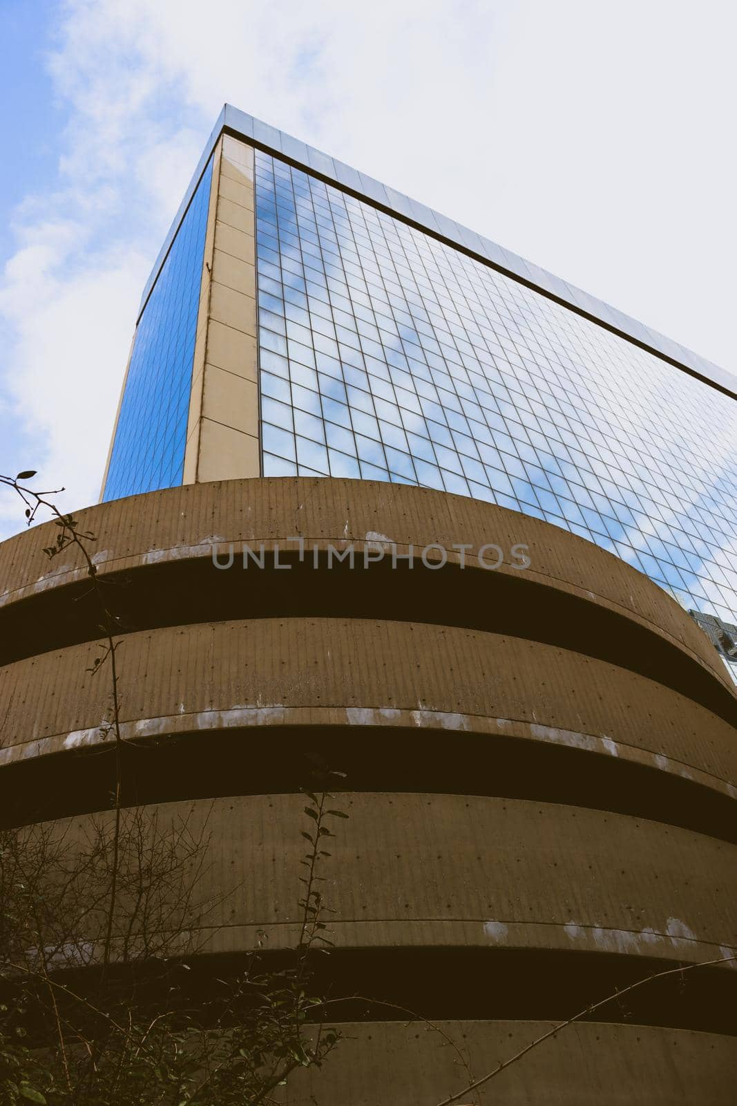 Genova, Italy-January 29, 2022: Beautiful modern high-rise buildings against the sky. 3d illustration on the theme of business success and technology. clouds reflection on the mirror.Industrial zone.