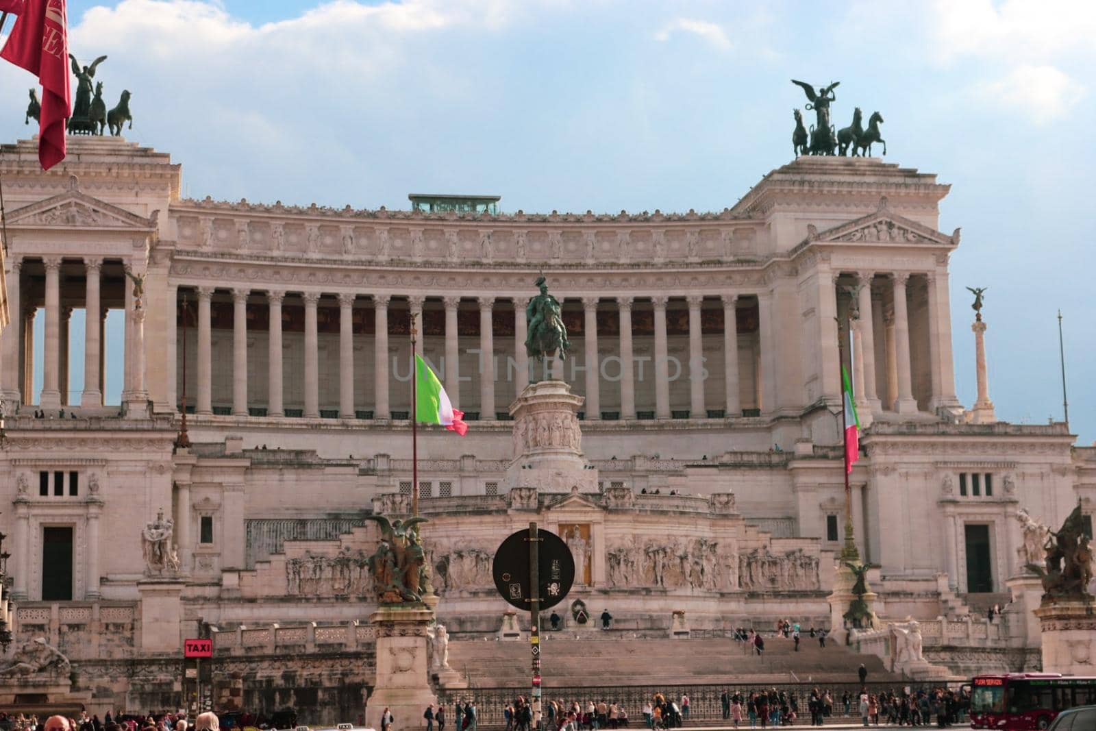 ROME, ITALY - February 05, 2022: Panoramic view around the Colosseum in city of Rome, Italy. Cold and gray sky in the background. Macro photography of the green parks with the old buildings.