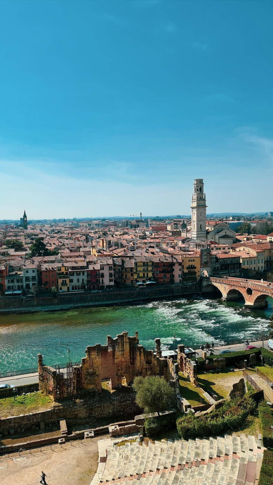 Verona, Italy-March 19, 2022: Beautifull old buildings of Verona. Typical architecture of the medieval period. Aerial view to the city with blue sky in the background. Detailed photography of the old architecture.