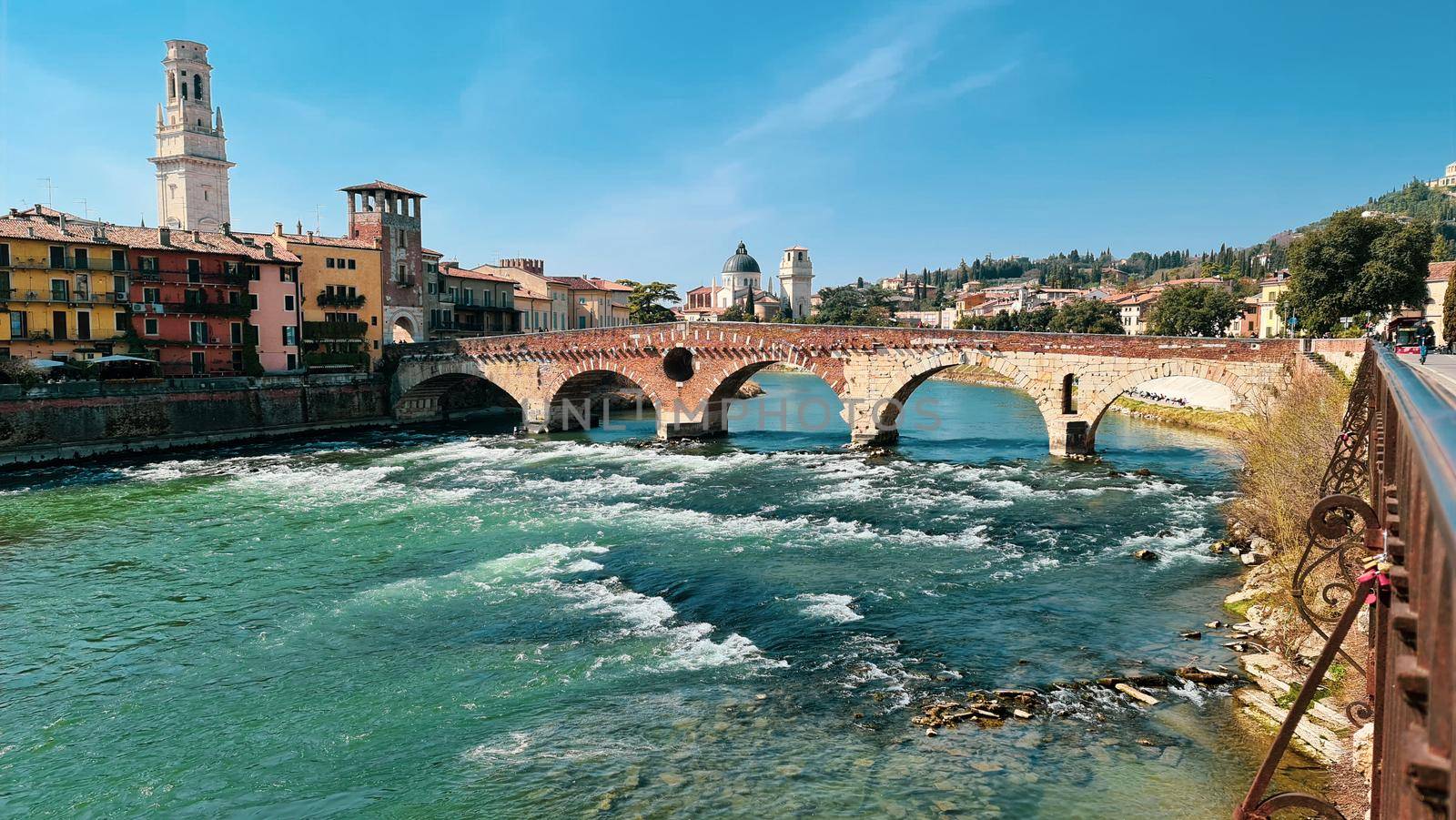 Verona, Italy-March 19, 2022: Beautifull old buildings of Verona. Typical architecture of the medieval period. Aerial view to the city with blue sky in the background. Detailed photography of the old architecture.