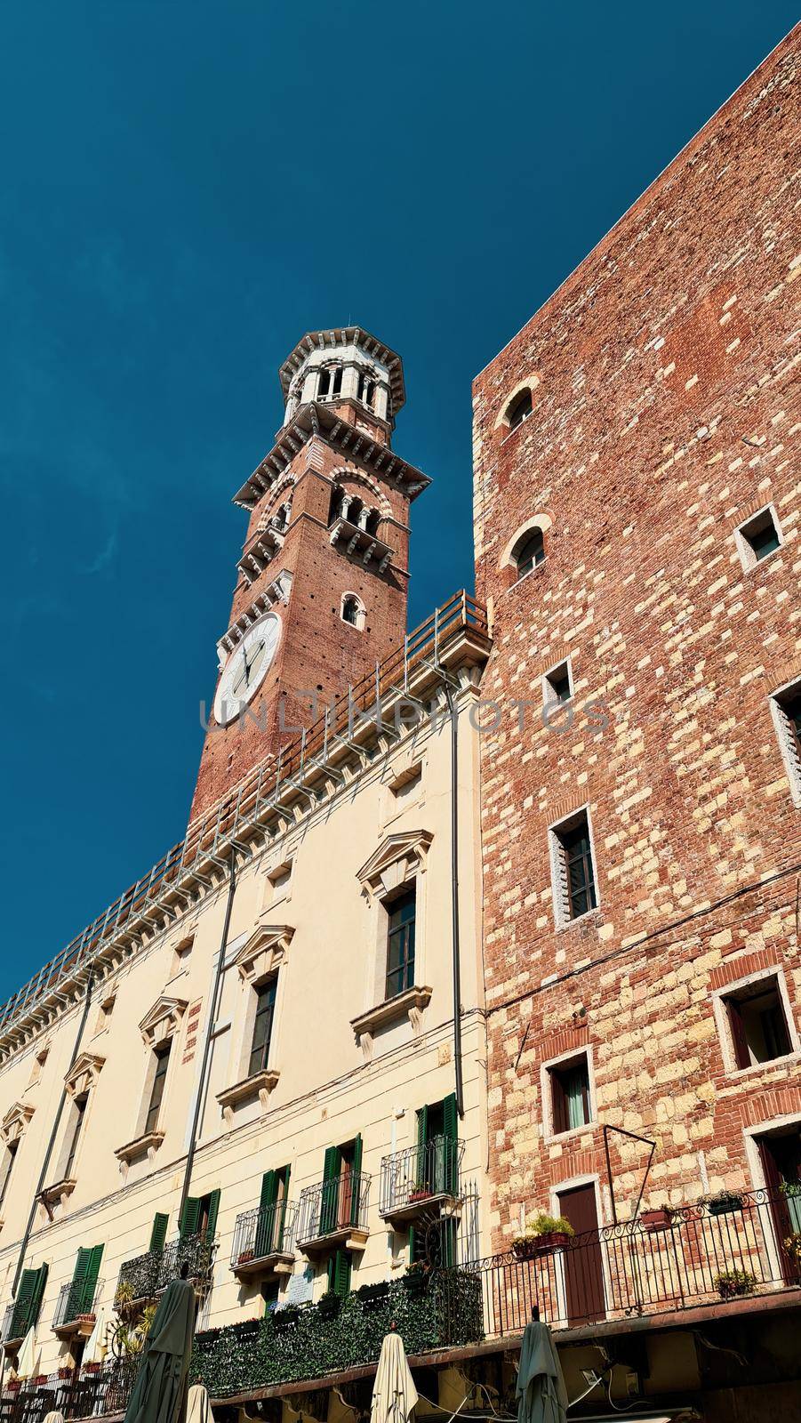 Verona, Italy-March 19, 2022: Beautifull old buildings of Verona. Typical architecture of the medieval period. Aerial view to the city with blue sky in the background. Detailed photography of the old architecture.