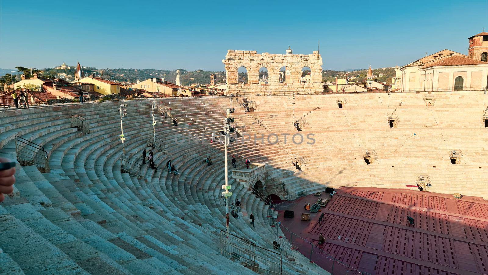 Verona, Italy-March 19, 2022: Beautifull old buildings of Verona. Typical architecture of the medieval period. Aerial view to the city with blue sky in the background. Detailed photography of the old architecture.