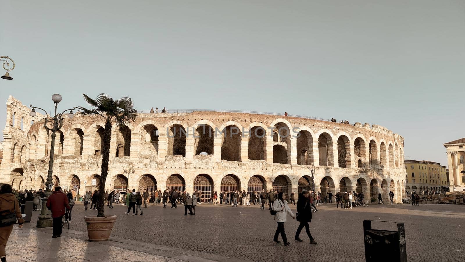 ROME, ITALY - February 05, 2022: Panoramic view of inside part of Colosseum in city of Rome, Italy. Cold and gray sky in the background. Macro photography of the arches.