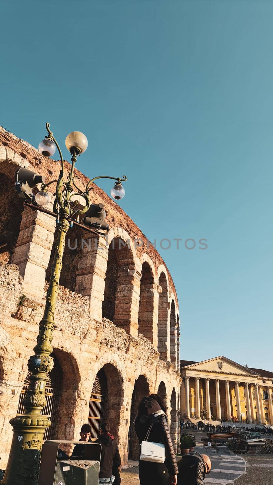 Verona, Italy - March 19, 2022: Aerial view of Verona historical city centre, Ponte Pietra bridge across Adige river, Verona Cathedral, Duomo di Verona, red tiled roofs, Veneto Region, Italy.