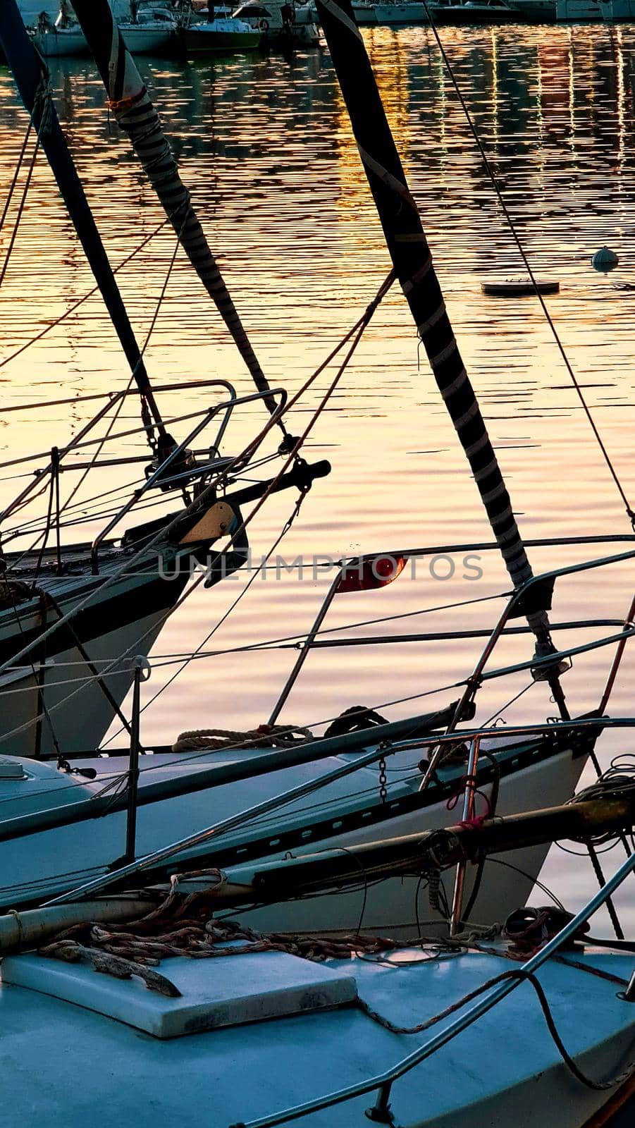 Genova, Italy - May 07, 2022: Panoramic view from the sea to the old town, and the port with beautiful sunset. Genoa bay, harbor, yacht at the pier.tourist destinations.