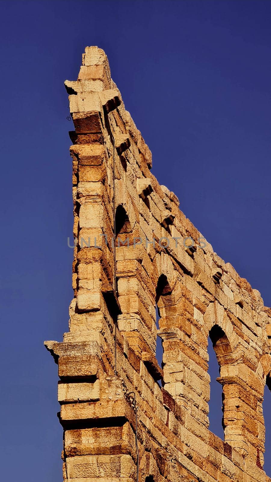 Verona, Italy - March 19, 2022: Beautiful photography of the Arena at Piazza Brà in Verona, a famous Roman amphitheater. Macro view of the old construction by day.