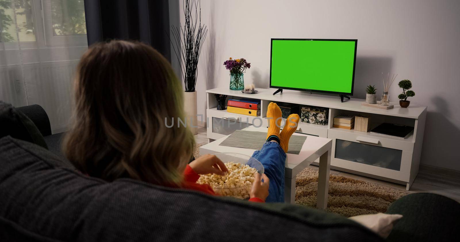 Young Woman Watching Television with Green Screen Chroma Key by RecCameraStock