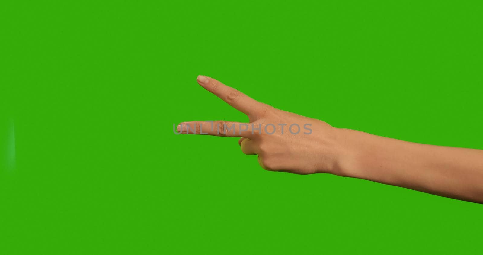 Gestures female Hand, the symbol of peace on a Green Background by RecCameraStock