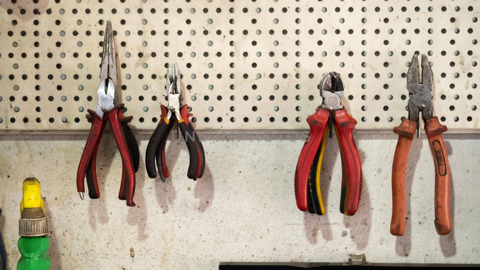 Pliers tools hanging on the wall by RecCameraStock