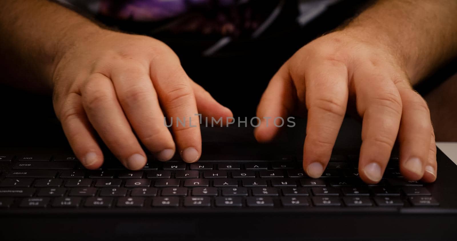 Man hands typing on laptop keyboard. Close up human hands on keyboard Front view.