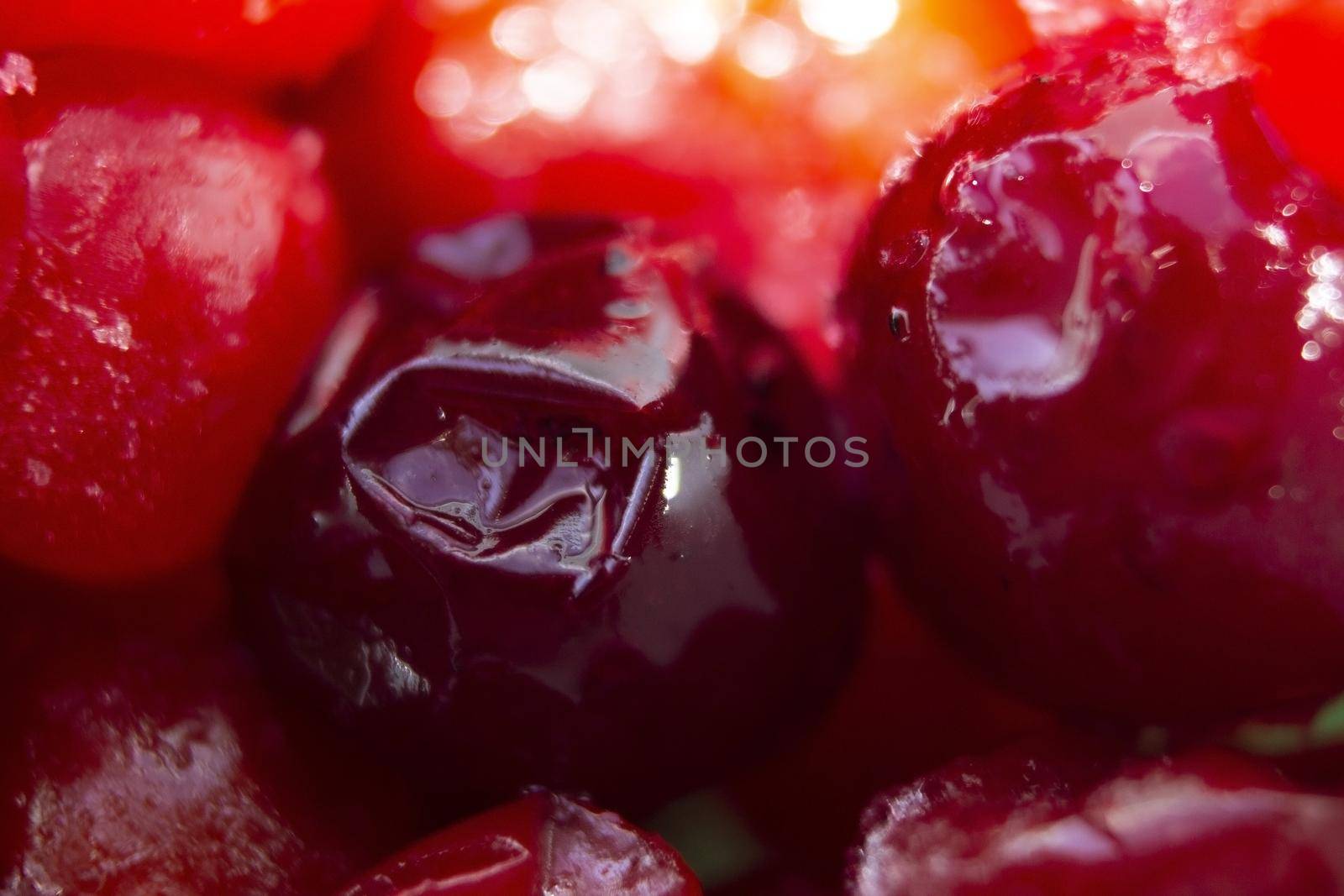 large frozen bright red berries with ice cubes
