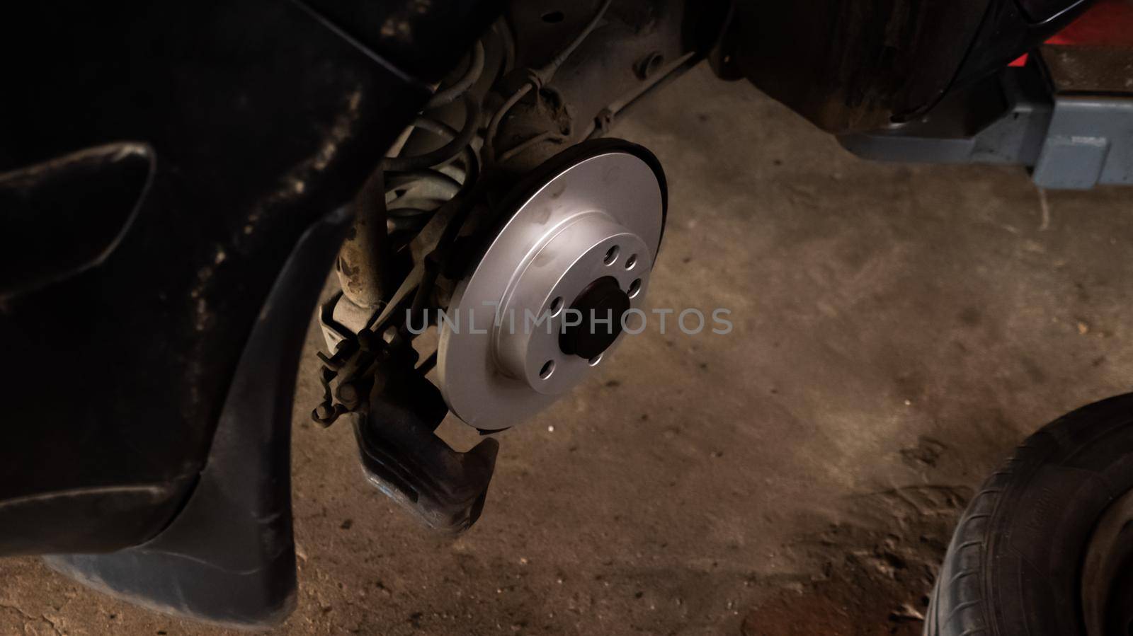 Replacing a new car brake disc., auto repair concept. by RecCameraStock